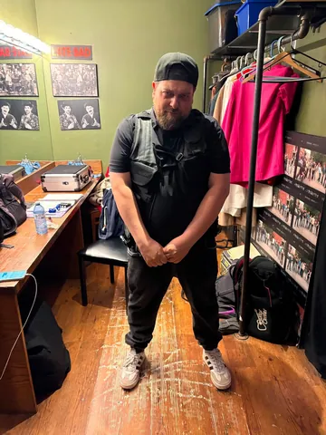 A performer backstage in a dressing room
