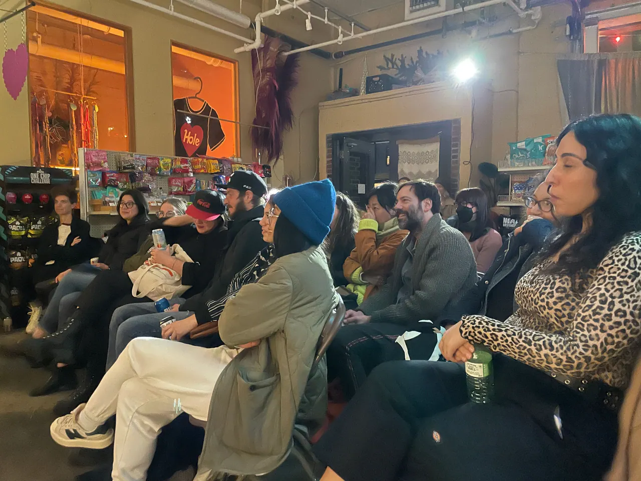 Rows of seated audience members watching a shop performance