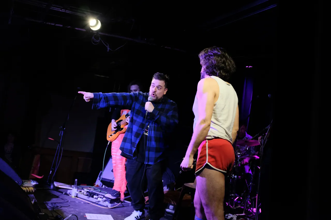 Two performers sharing the stage at InterDANmentional, with a live band behind them
